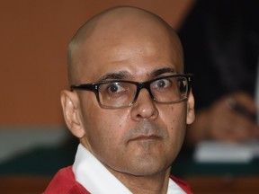 Canadian teacher Neil Bantleman sits inside a court room while waiting for his trial on Dec. 2.