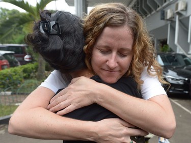 Tracy Bantleman hugs Siska Tjiong, wife of Indonesian teaching assistant Ferdianand Tjiong, after attending their hearings at the South Jakarta court.
