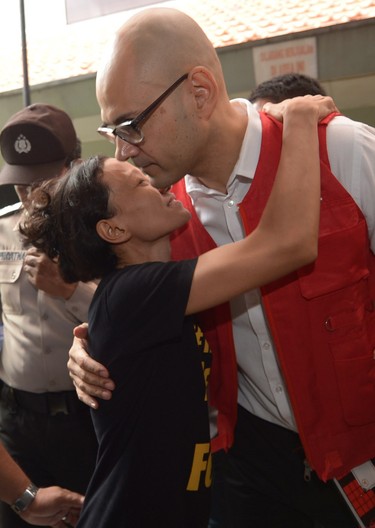 Canadian teacher Neil Bantleman is hugged by Siska Tjiong, his co-accused's wife.