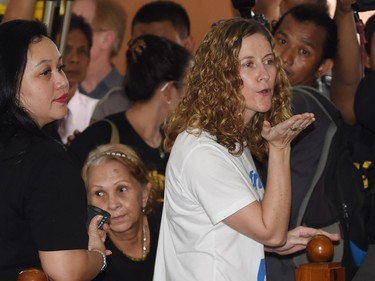 Tracy Bantleman (C) blows a kiss to her husband Neil, as the audience leaves the closed-door trial at the South Jakarta court.