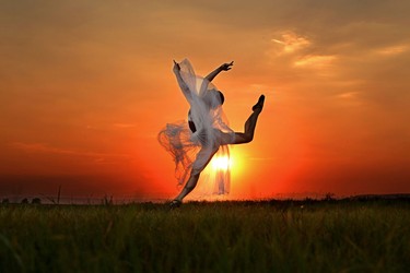 Ballet dancer Nicole Le Roux leaps into the air as the sun sets on a hot summer evening near Okotoks on August 12, 2014.