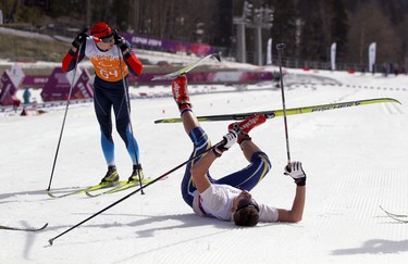 Ukrainian Lurii Utkin collapses at the finish line during the men's 20km visually impaired cross-country-skiing at the Paralympic Winter Games on March 10, 2014 in Sochi, Russia.