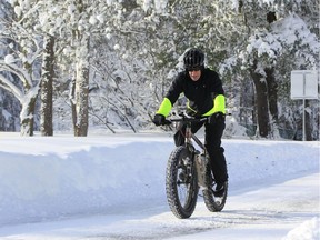 Bill Graves rides his bike on the snow at Chrsnut Ridge Park, Orchard Park,NY on Wednesday, Nov. 19, 2014.