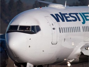 A pilot taxis a Westjet Boeing 737-700 plane to a gate at Vancouver International Airport.