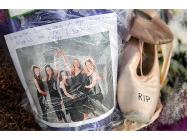 Calgary's Kaitlyn Harris and Kaitlyn MacArthur laid flowers and a pair of ballet shoes to the growing memorial on Butler Crescent on April 16, 2014. They were friends with Kaitlin Perras who was one of the five victims.