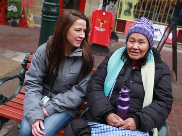 Tanya Richer, an outreach worker with the Canadian Mental Health Associations' Street Outreach and Stabilization (SOS) team, talks with a homeless woman on Stephen Avenue Mall that she has known for several years. Up to seventy per cent of homeless individuals have a mental health concern.