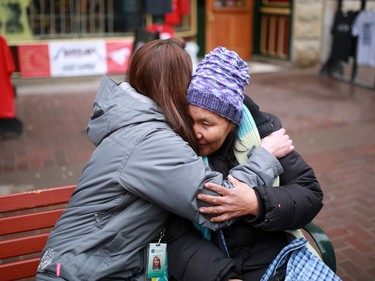 Tanya Richer, an outreach worker with the Canadian Mental Health Associations' Street Outreach and Stabilization (SOS) team, hugs a homeless woman on Stephen Avenue Mall that she has known for several years.