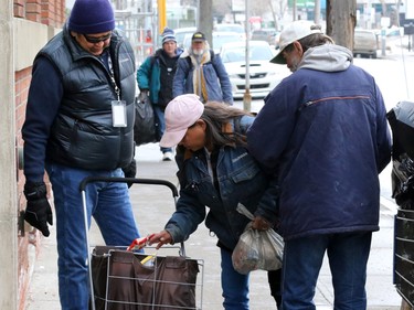 John Chief Moon, an outreach worker with the Canadian Mental Health Associations' Street Outreach and Stabilization (SOS) team, hands out food to bottle collectors in Calgary's beltline. The team regularly hands out small food hampers and makes connections with those living on the street.  Up to seventy per cent of homeless individuals have a mental health concern. The SOS team helps to address the needs of these hard to reach individuals by connecting and working with them.