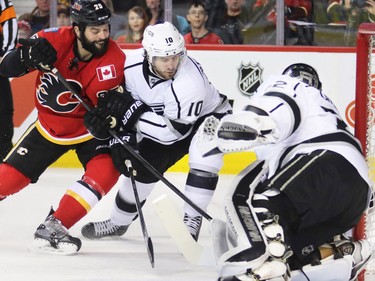The Calgary Flames' Brandon Bollig and the King's Mike Richards fight for the puck in front of the Los Angeles Kings' Jonathan Quick during third period NHL action in Calgary. The Flames won 2-1.
