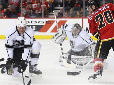 The Calgary Flames' Curtis Glencross and the King's Matt Greene scramble in front Los Angeles Kings' goaltender Jonathan Quick during first period NHL action in Calgary.