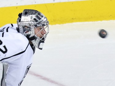 The Los Angeles Kings' Jonathan Quick watches as a puck flies towards him during second period NHL action in Calgary.