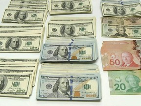 CBSA officers seized more than $84,000 in US and Canadian currency as suspected proceeds of crime from a traveller at the Calgary International Airport on Dec. 8, 2014.