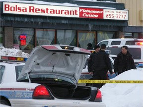 Janruary 01, 2009-Police investigate the scene of the multiple shooting which left three people dead in the Macleod Plaza strip mall.
