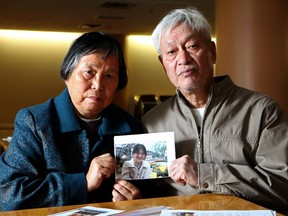 Jinling Huang and her husband Zhiming Chen hold a photo of their daughter Yinghua Chen, a Falun Gong practitioner imprisoned in China.