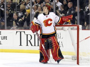 Jonas Hiller #1 of the Calgary Flames reacts after allowing a goal to Rob Klinkhammer #20 of the Pittsburgh Penguins (not pictured) during the game at Consol Energy Center on December 12, 2014 in Pittsburgh, Pennsylvania.