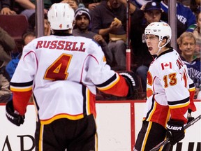 Johnny Gaudreau of the Calgary Flames celebrates with Kris Russell after scoring a goal against the Vancouver Canucks on Saturday.
