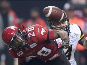Calgary Stampeders' defensive back Brandon Smith fights for control of the ball with Hamilton Tiger-Cats' quarterback Zach Collaros during the first half of the 102nd Grey Cup in Vancouver last month.