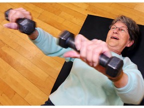 FILE - June Knowles lifts some weights during strengthening exercises during a 50-plus cardio fitness class at the Southland Leisure Centre.