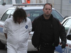Gregory Houle, being brought in for processing by police on November 5, 2011.