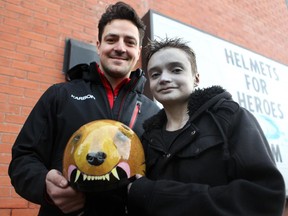 Canadian Luge Olympian Sam Edney, left, and young artist Richard Flamenco held the helmet Flamenco designed for Edney to wear as part of the Helmets for Heroes program. Flamenco suffers from Epidermolysis Bullosa, which causes painful blistering of the skin. They were photographed on December 11, 2014.