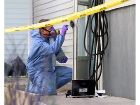 Crime scene investigators examine the home of Alvin and Kathy Liknes in July 2014, following the disappearance of the couple and their five-year-old grandson, Nathan O'Brien.