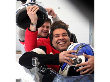 Mayor Naheed Nenshi braces himself for a run down the bobsleigh track at Canada Olympic Park with Canadian Olympic bobsledder Jesse Lumsden and Rob Cote of the Stampeders on December 14, 2014.