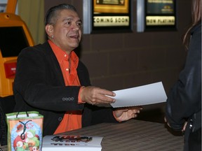 Lorne Cardinal, Sergeant Davis Quinton from Corner Gas: The Movie, signs autographs for fans after making a surprise appearance at Scotiabank Theatre Chinook in Calgary on Wednesday.