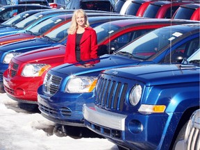 Vicki Appleby, president of Crowfoot Dodge,stands along side a row of new vehicles,in the new car lot at  Crowfoot Dodge.
