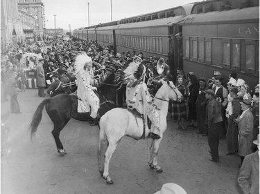 Dec 1, 1948 - Fans, including natives  in costume, meet the train with the Grey Cup winning  Calgary Stampeders.