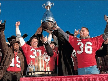 DECEMBER 1, 1992 -  The Grey Cup champion Stampeders are 
Honoured guests during an Olympic Plaza ceremony that followed a parade through downtown Calgary.  Surrounding Canadian football's top prize are (from left) Errod Tucker, Mark McLoughlin, Karl Anthony, Matt Finlay, Bob Torrance and  Blair Zerr.