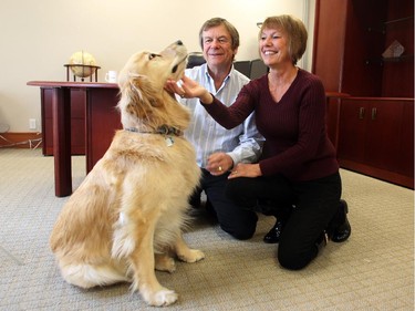 Morrow, a golden retriever, and his people, Ron and Judy Quigley, owners of Gunnar Office Furnishings were photographed on November 27, 2014. The office has been canine friendly since it opened.