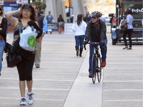 A cyclist rides down Stephen Avenue in Calgary, Alberta Tuesday, April 29, 2014.  According to the city's latest update to its cycle track plans, Stephen Avenue is likely to become the busiest bikeway in the pilot project network.