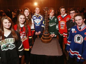 Players from all the Calgary team's competing in this years Mac's Midget Hockey Tournament stand with a tournament trophy following a press conference for the event on Wednesday.