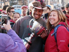 Red Deer's Michelle Skilmick posed for a photo with Nik Lewis and the Grey Cup following the Calgary Stampeders Grey Cup celebration rally at Calgary City Hall on Tuesday. The longtime Stampeder is eligible for free agency and there is doubt whether he will be back in Calgary next season.