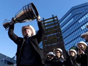 Calgary Stampeders quarterback Bo Levi Mitchell hoists the Grey Cup during the Grey Cup Champions rally at City Hall in Calgary on Tuesday. Expect a fair amount of turnover on the Grey Cup champs next season as a number of players are eligible for free agency.