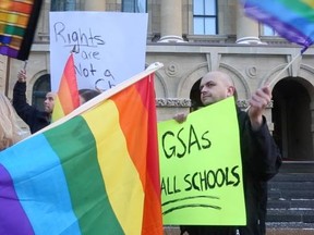 Calgarians, including members of the LGBTQ community, rally against Bill 10 outside the McDougall Centre earlier this month.