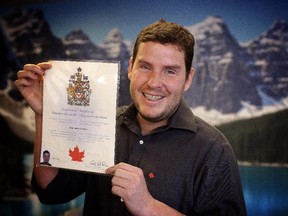 Jose Neto with his Canadian citizenship during a ceremony at Harry Hays in Calgary on December 5, 2014.