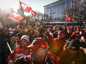 Calgary Stampeders fans celebrate the team winning the Grey Cup during a rally in Calgary, on Tuesday.