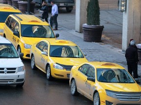 Cabs wait for fares outside the downtown Calgary Marriott on Thursday December 4, 2012.