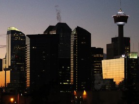 Calgary's downtown skyline and glass towers are lit up at sunset on Sunday November 16, 2014.