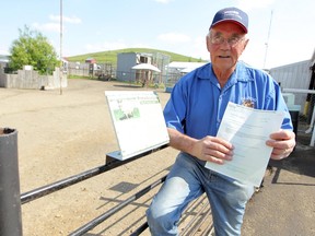 Lynn Gustafson holds a temporary zoo renewal permit for the GuZoo animal farm in this June 2011 file photo.