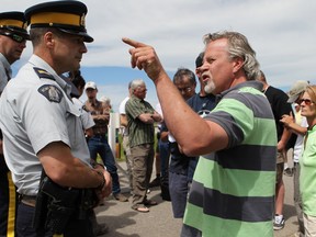 Residents confronted the RCMP on the edge of High River in a bid to enter the town, one week after the Highwood River flooded in June 2013.