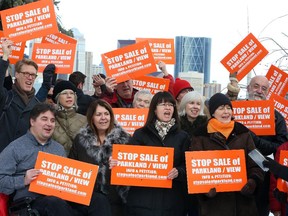 The community protests against the proposed sale of city parkland to a private landowner in Calgary on December 6, 2014.