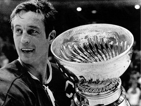 In this May 19, 1971, file photo, Montreal Canadiens team captain Jean Beliveau holds the Stanley Cup in Chicago following the Canadiens' 3-2 victory over the Chicago Blackhawks. Former Calgary Flames head coach Al MacNeil was the bench boss of that team.