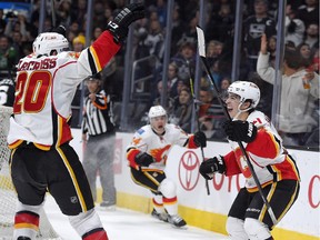 Calgary Flames rookie Johnny Gaudreau, right, celebrates his third goal of the game with Curtis Glencross, left, and Jiri Hudler, of the Czech Republic, during the third period against the Los Angeles Kings on Monday.