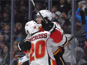 Calgary Flames rookie Johnny Gaudreau, right, celebrates his third goal of the game with Curtis Glencross against the Los Angeles Kings on Monday. Thanks to his natural hat-trick in regulation, Calgary snapped an eight-game losing streak with a 4-3 come-from-behind win.