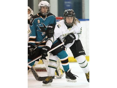 Rocky Mountain Raiders defenceman Cassidy Trotter, right, battle in front of her teams net with Battleford Sharks forward Maya Tupper during their Mac's AAA Midget Female Division game at the Max Bell Arena on December 26, 2014.