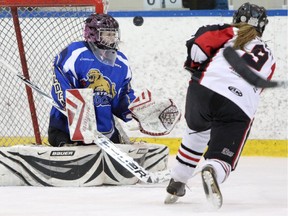Westman Wildcats goalie Jenna Marshall, left blocks a shot on net from Northern Cougars Jocelyn Forrest during the Mac's Midget Hockey Tournament at Max Bell arena in Calgary on December 28, 2014.