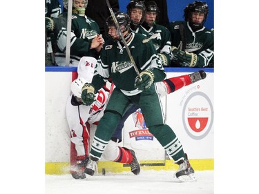 Calgary Northstars defenceman Kyle Yewchuk, right, Lethbridge drove Hurricanes forward Laramie Kostelansky into the boards near the benches during their Mac's AAA Midget Tournament at Max Bell Arena on December 27, 2014.