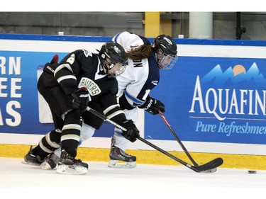 Edmonton Thunder forward Morgan Casson, right, battled for the puck with Rocky Mountain Raiders forward Kennedy Brown, left, during their Mac's AAA Midget Tournament at Max Bell Arena on December 27, 2014.